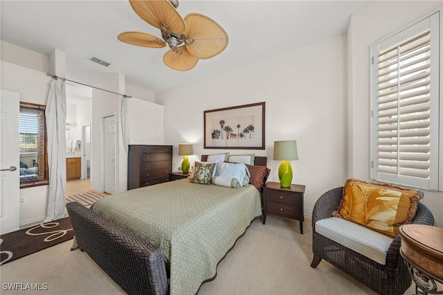 6683 Castlelawn Pl, Naples, FL 34113 - bedroom with visible vents, light colored carpet, a ceiling fan, and connected bathroom