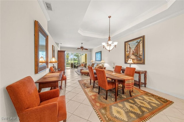 6683 Castlelawn Pl, Naples, FL 34113 - dining area with visible vents, light tile patterned floors, ornamental molding, a tray ceiling, and ceiling fan with notable chandelier