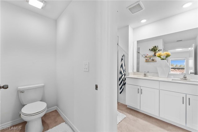 20160 Caroline Creek Pl, Lehigh Acres, FL 33974 - bathroom with toilet, double vanity, tile patterned flooring, and baseboards