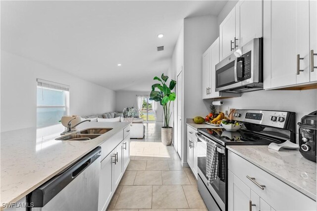 20160 Caroline Creek Pl, Lehigh Acres, FL 33974 - kitchen featuring appliances with stainless steel finishes, a sink, healthy amount of natural light, open floor plan, and recessed lighting