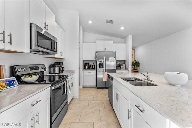 20160 Caroline Creek Pl, Lehigh Acres, FL 33974 - kitchen featuring appliances with stainless steel finishes, a sink, light stone countertops, white cabinets, and lofted ceiling