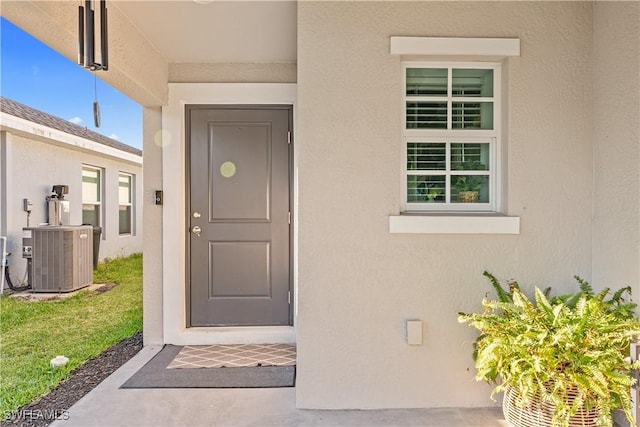 20160 Caroline Creek Pl, Lehigh Acres, FL 33974 - property entrance with cooling unit and stucco siding