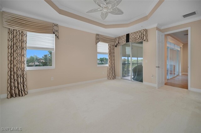 6532 Monterey Pt Unit 202, Naples, FL 34105 - carpeted spare room featuring crown molding, ceiling fan, a tray ceiling, and baseboards