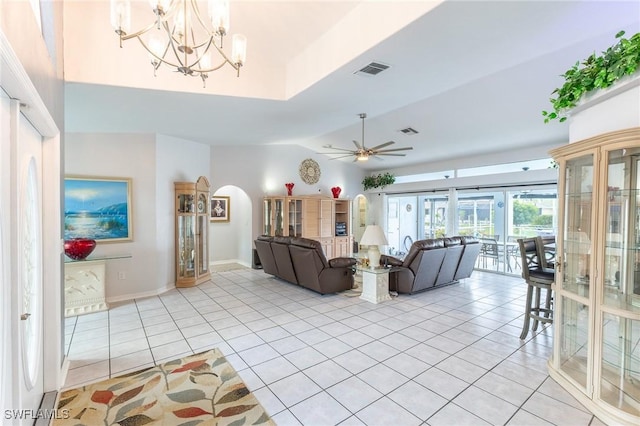 living area featuring arched walkways, visible vents, and light tile patterned flooring