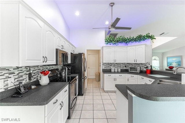 kitchen with black range with electric stovetop, ceiling fan, dark countertops, stainless steel microwave, and a sink