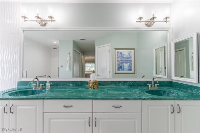 full bath featuring double vanity and a sink
