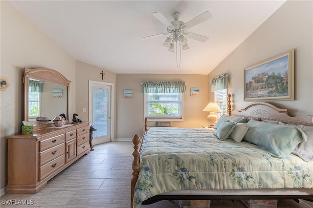 bedroom with baseboards, a ceiling fan, lofted ceiling, access to exterior, and light wood-type flooring