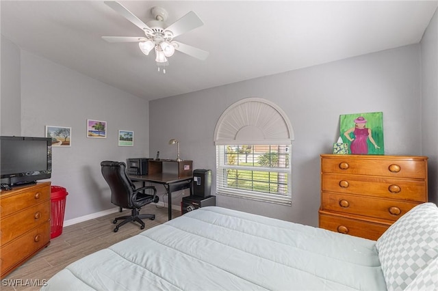 bedroom with baseboards, ceiling fan, and wood finished floors