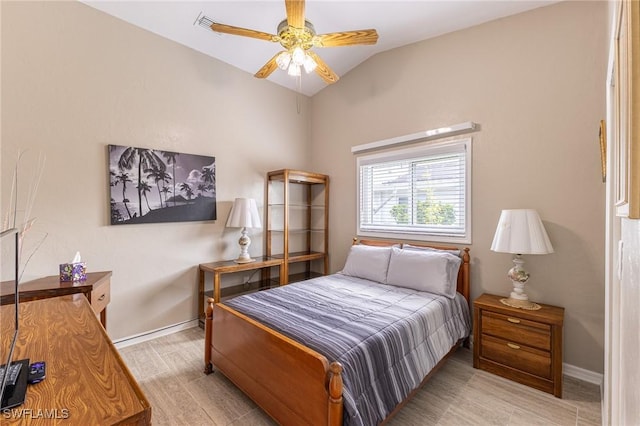 bedroom featuring baseboards, lofted ceiling, and ceiling fan