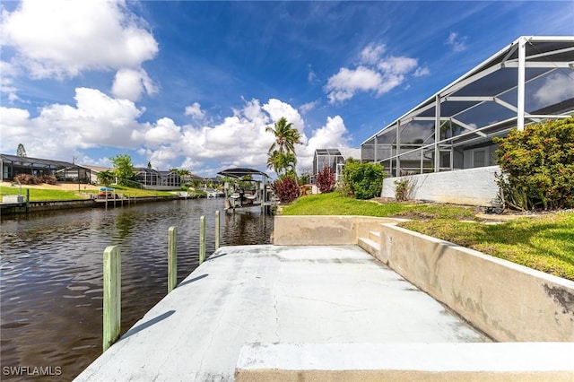 view of dock with a water view and glass enclosure
