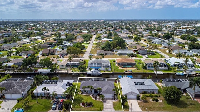 drone / aerial view with a water view and a residential view