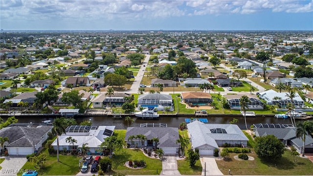 drone / aerial view featuring a water view and a residential view