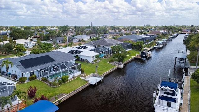 birds eye view of property with a water view and a residential view