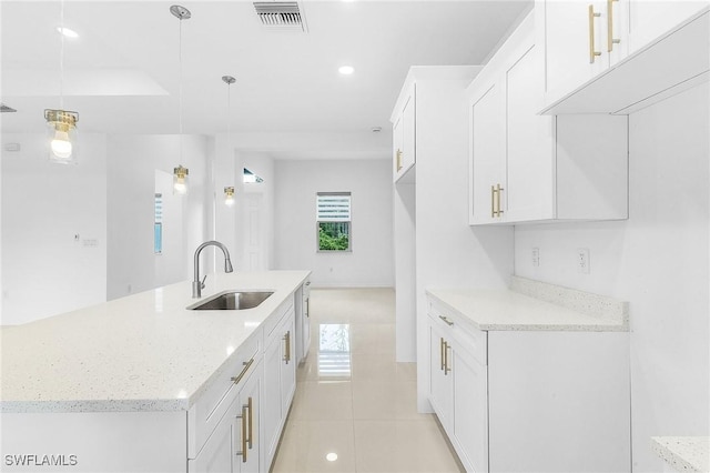 1606 Euclid Ave, Lehigh Acres, FL 33972 - kitchen with a sink, white cabinetry, light stone countertops, light tile patterned flooring, and recessed lighting