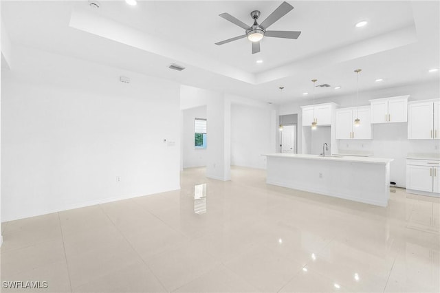 1606 Euclid Ave, Lehigh Acres, FL 33972 - unfurnished living room featuring a raised ceiling, a sink, recessed lighting, and ceiling fan