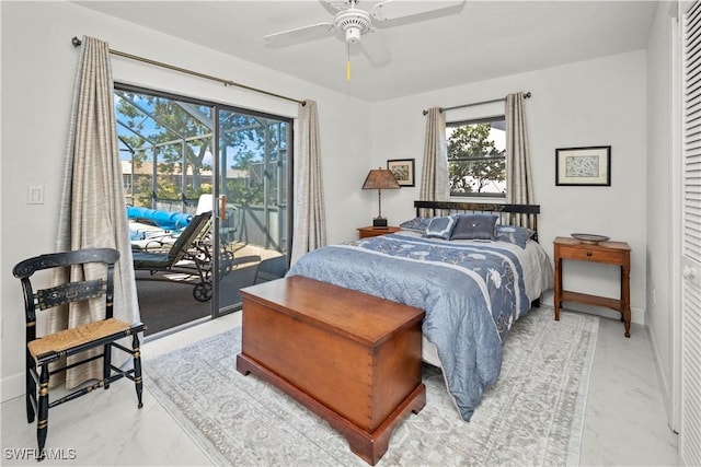 bedroom featuring multiple windows, access to outside, and marble finish floor