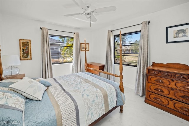 bedroom featuring a ceiling fan and multiple windows