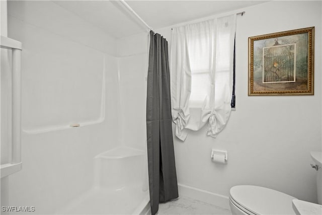 bathroom with baseboards, marble finish floor, a shower with curtain, and toilet