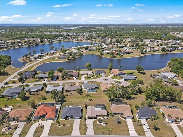bird's eye view featuring a water view and a residential view