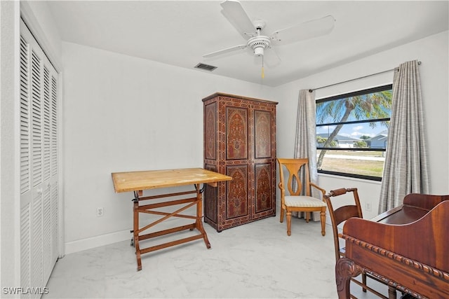 sitting room featuring visible vents, marble finish floor, baseboards, and ceiling fan