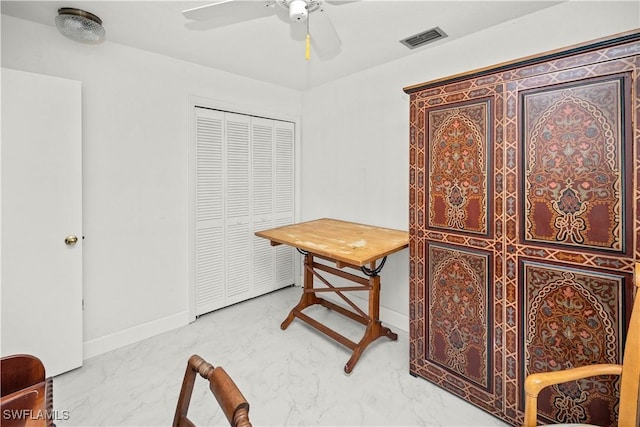 home office featuring visible vents, baseboards, a ceiling fan, and marble finish floor