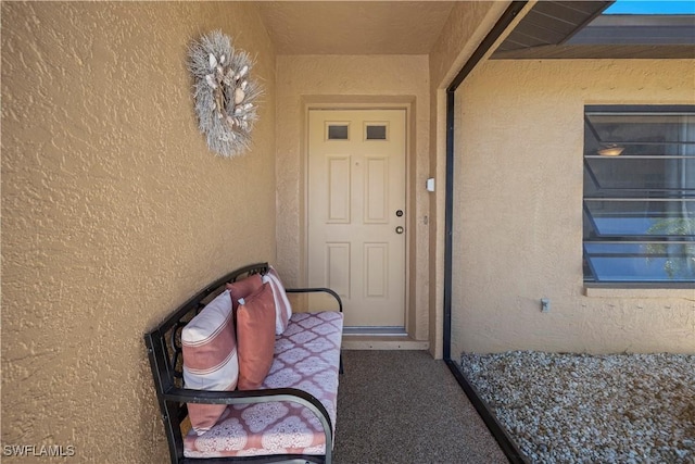 property entrance featuring stucco siding