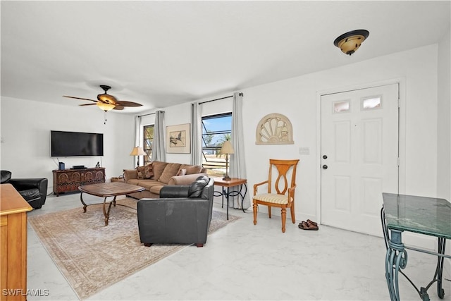 living area with marble finish floor and ceiling fan
