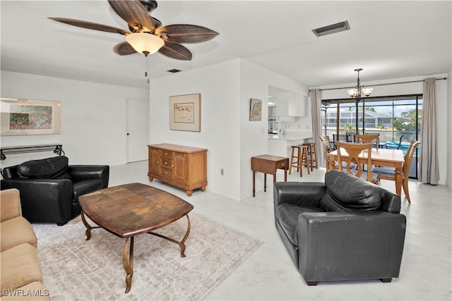 living room with marble finish floor, visible vents, and ceiling fan with notable chandelier