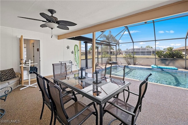 exterior space featuring a fenced in pool, a patio, glass enclosure, and ceiling fan