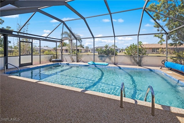 pool featuring a patio, a residential view, and a lanai