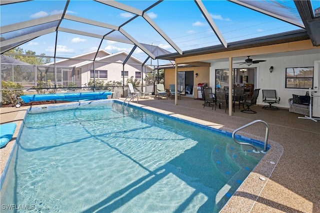 view of pool featuring a patio area, a lanai, a ceiling fan, and a covered pool