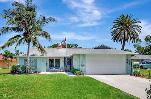 ranch-style home with a shingled roof, concrete driveway, a garage, and a front lawn