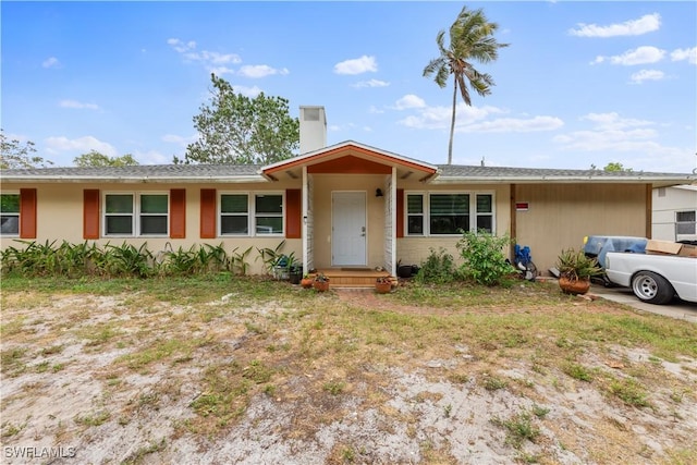 3586 Croton Rd, Naples, FL 34104 - ranch-style house featuring stucco siding and a chimney