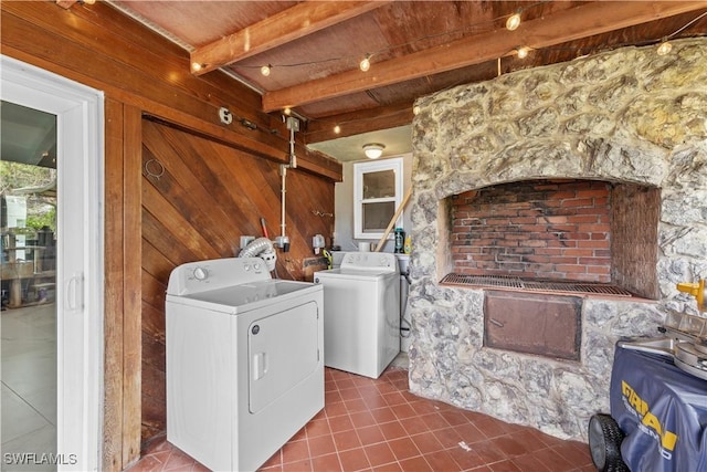 3586 Croton Rd, Naples, FL 34104 - washroom featuring washing machine and dryer, wooden walls, laundry area, and tile patterned flooring