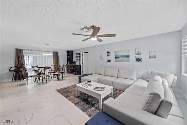 3586 Croton Rd, Naples, FL 34104 - living room featuring baseboards, a textured ceiling, marble finish floor, visible vents, and a ceiling fan