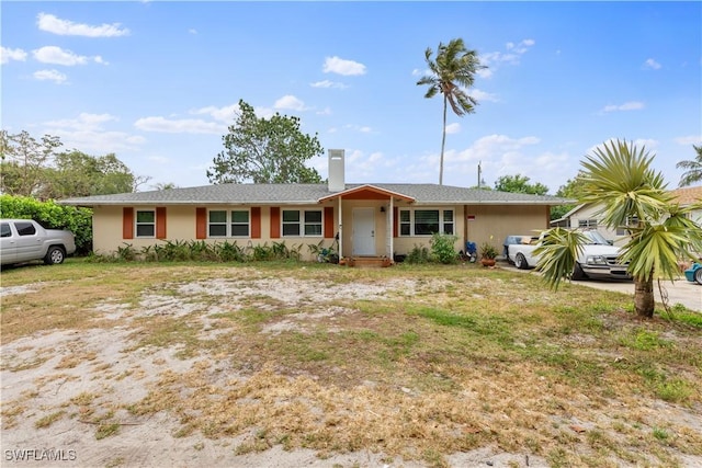 3586 Croton Rd, Naples, FL 34104 - ranch-style house with stucco siding and a chimney