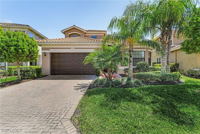 10079 Chesapeake Bay Dr, Fort Myers, FL 33913 - mediterranean / spanish home featuring a tile roof, a front yard, stucco siding, decorative driveway, and a garage