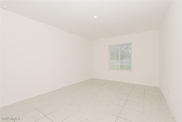 unfurnished room featuring recessed lighting and light tile patterned floors