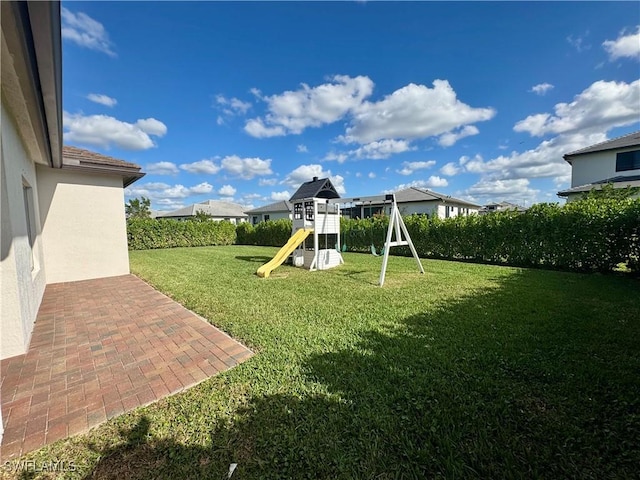 view of yard with a playground and a patio area