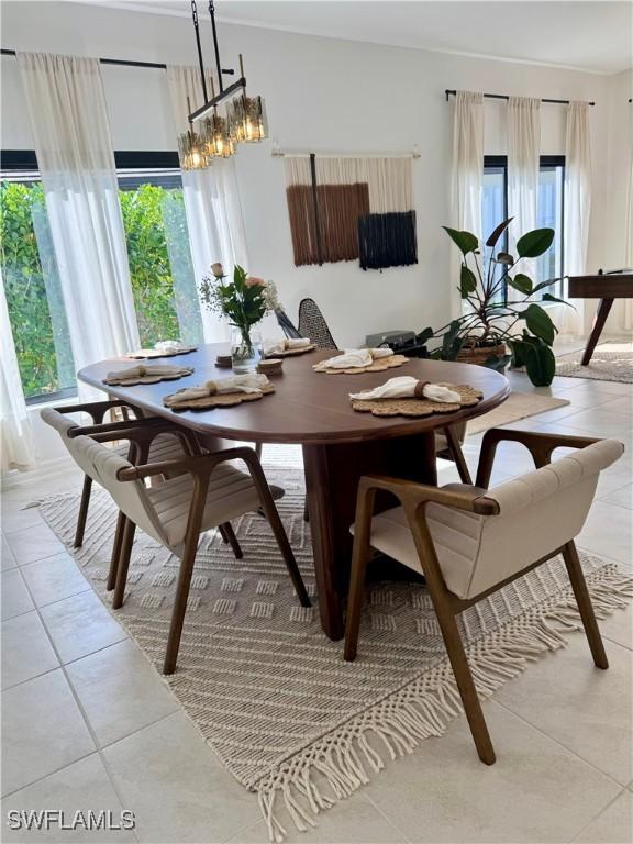 dining room with a chandelier and light tile patterned floors