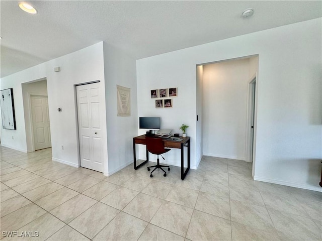 home office featuring light tile patterned floors and baseboards