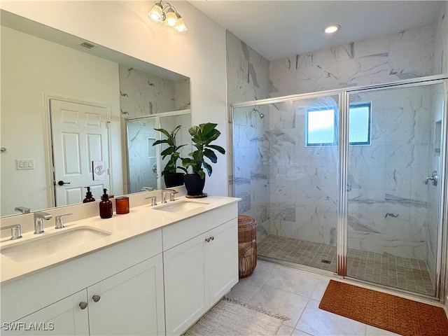 full bathroom featuring double vanity, recessed lighting, a sink, and a marble finish shower