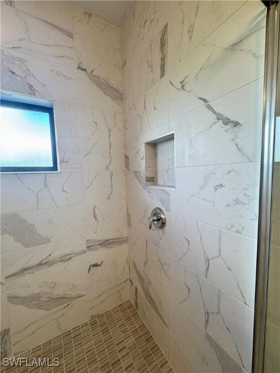 full bath featuring a tile shower