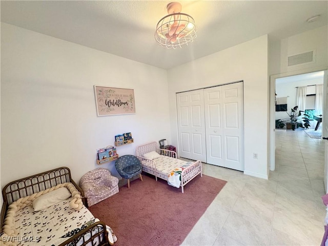 bedroom with a closet, baseboards, and visible vents