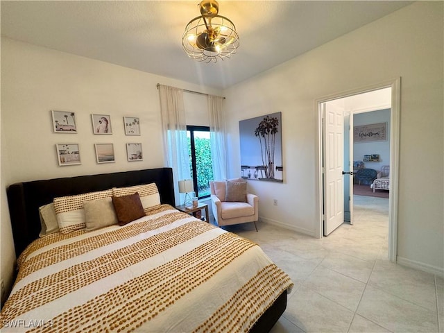 bedroom with baseboards and light tile patterned floors