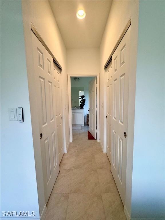hall featuring baseboards