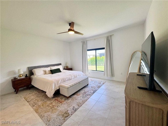 bedroom with light tile patterned flooring, ceiling fan, and baseboards
