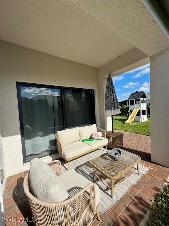 view of patio / terrace featuring an outdoor living space and a playground