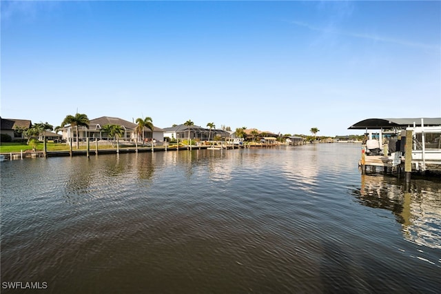 property view of water with boat lift, a dock, and a residential view