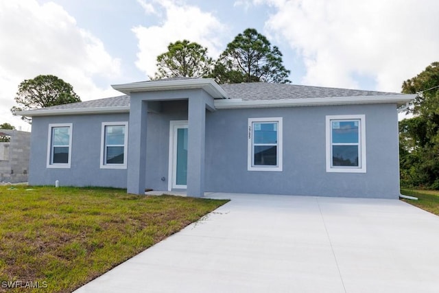 ranch-style home with a shingled roof, stucco siding, concrete driveway, and a front lawn